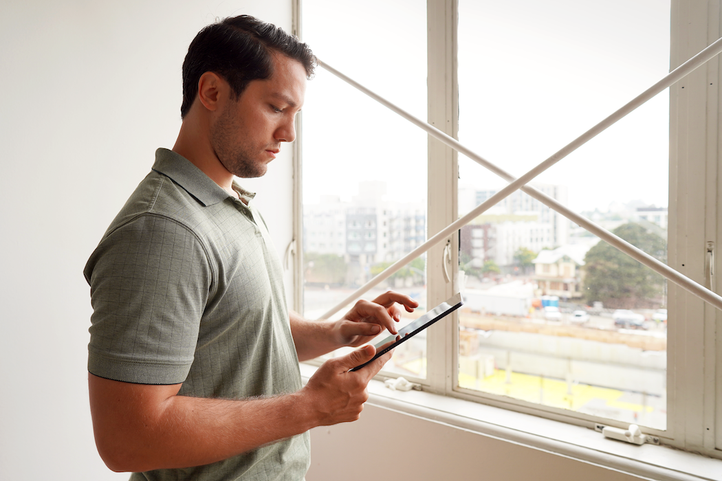 man with image of ipad looking to the right using it for mobile forms data