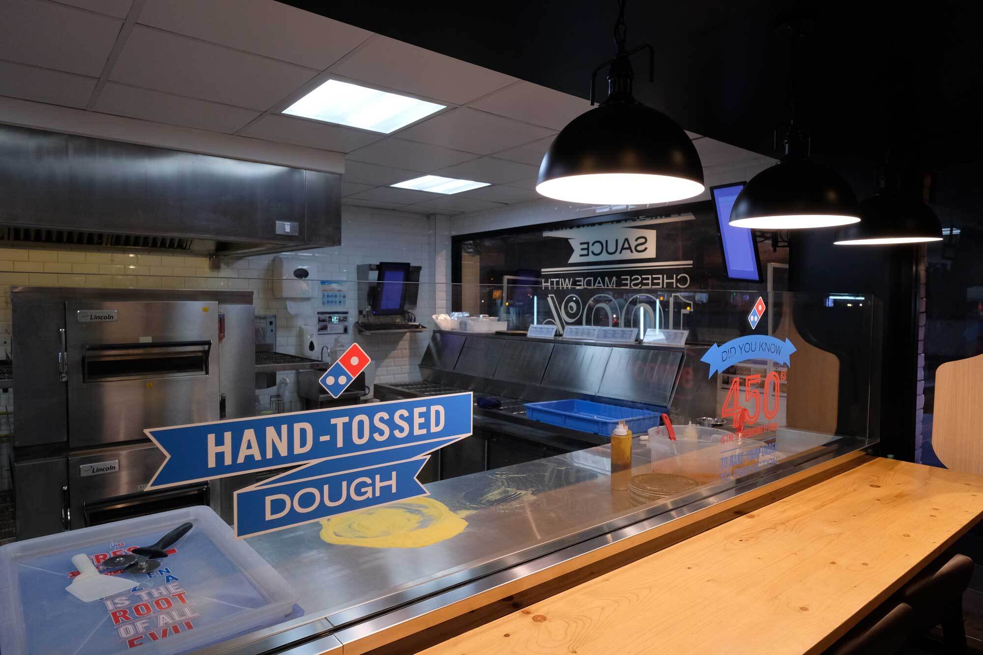 Photograph of a Domino's Pizza kitchen at night